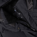 Close-up view of a black puffer jacket with a soft lining and zip closure, displaying its inner texture and finish.