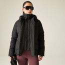 Woman modelling a black padded hooded jacket with high collar and front fastening.