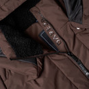 Close-up of dark brown padded jacket showing the soft fleece lining, zip fastening and branded inner detail.