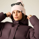 Close-up of woman adjusting the hood of a dark purple padded winter coat.
