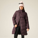 Woman modelling a long dark purple padded coat with hood, high collar and side pockets.