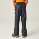 Rear view of Regatta children’s navy Stormbreak waterproof overtrousers with elasticated waistband and loose fit.