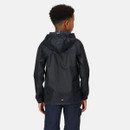 A child with curly hair, viewed from the back, wearing a black hooded rain jacket and dark pants, stands against a plain white background.