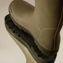 Close-up of Le Chameau men's green wellington boots showing the textured rubber uppers and deep-tread Grip/Cross soles.