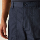 Close-up navy work trousers waistband with button, durable cargo utility pants front detail