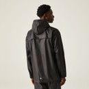 A person wearing a black hooded rain jacket faces away from the camera against a neutral background, conveying a sense of calm and readiness.