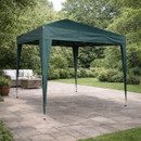 Green pop-up garden gazebo with metal frame set on a patio in a landscaped garden.