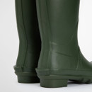 Close-up of green Barbour wellington boots showing rubber texture and reinforced heel area.