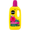 Bright yellow Miracle-Gro bottle with pink cap, featuring images of vibrant flowers and blueberries. Labels highlight it's for azaleas, camellias, and rhododendrons. Bold, energetic tone.