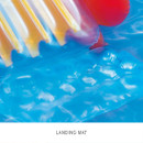 Close-up of the inflatable landing mat at the bottom of a water slide with rippling blue water