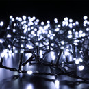 White LED décor tree lights illuminated on a dark surface, featuring densely arranged cool white bulbs on a green cable for Christmas and seasonal decorations.