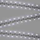 White LED compact Christmas tree lights arranged in parallel strands on a neutral background, highlighting evenly spaced cool white bulbs and green wiring.