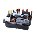 Black plastic toolbox with a central handle, containing screwdrivers, a tape measure, a transparent case with nails, bottles, and cleaning cloths. Tidy and organized.
