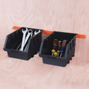Two black plastic bins are mounted on a wooden wall. The left bin holds silver wrenches, and the right bin contains screwdrivers with coloured handles.