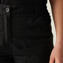 Close-up of women’s black work trousers waistband with button closure, belt loops, and reinforced stitching, durable utility pants detail.
