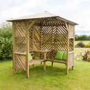 Wooden corner garden arbour with built-in bench seating and slatted sides on a lawn.