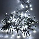 Illuminated white cluster string lights bundled together, highlighting the dense LED arrangement and bright cool white festive glow.