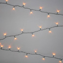 Antique white LED string lights with warm vintage-style bulbs on a green cable, displayed in parallel strands against a light grey background for festive indoor and outdoor decorating.