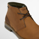 Close-up of Barbour Readhead chukka boot in tan leather showing lace fastening and embossed Barbour branding.