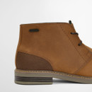 Close-up side view of tan Barbour Readhead chukka boot with stitched leather upper and rubber sole.