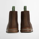 Back view of brown leather Chelsea boots highlighting pull tabs and layered sole construction.