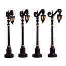 Set of four illuminated Victorian-style street lamps with black and gold detailing, ideal for Christmas village displays, model railways and festive winter scenes.
