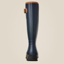 Blue knee-high boot with brown trim and buckle, shown from the back against a beige background. The sole is dark with "ARIAT" embossed on it. Sleek and stylish.