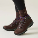 Brown leather walking boots with purple laces and rugged grip soles, worn with brown hiking socks and black leggings.