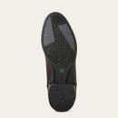 Sole of a boot with a dark tread pattern, featuring textured geometric shapes for grip. The brand logo is visible in green near the heel.