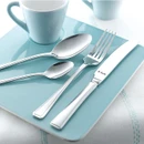 Polished stainless steel cutlery set with table spoon, teaspoon, fork and knife arranged on a light blue plate beside a matching cup.