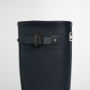 Detailed view of the adjustable buckle strap on navy Barbour wellington boots with embossed branding.