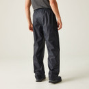 A person wearing navy rain trousers and grey shoes stands on a plain light background. The casual stance suggests a relaxed mood.