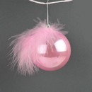 A pink bauble with a feather at the top, against a grey background.