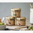 Three jars of Edinburgh Preserves pâté including Duck, Chicken Liver, and Venison, displayed on a rustic table with olives and bread.