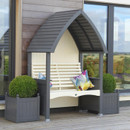 Charcoal and cream painted garden arbour bench with curved slatted roof, styled with colourful cushions and matching square planters with topiary balls.