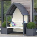 Front view of charcoal roofed, cream garden arbour bench with slatted back, flanked by charcoal planters holding round topiary.