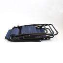 A folded navy blue lounge chair with a black metal frame, showcasing a compact design for easy storage.