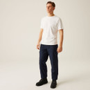Full-body shot of male model wearing navy blue work trousers with white t-shirt and black boots, showcasing relaxed fit, straight leg silhouette, and durable everyday workwear styling