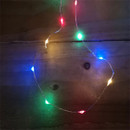 Close up of Premier 200 Multi-Action LED Battery-Operated Microbrights Multicoloured - 10m pn a wooden background