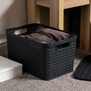 Grey plastic storage basket without lid, filled with soft furnishings, featuring textured woven pattern and integrated side handles, ideal for home organisation and textile storage.