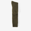 A pair of green wool socks folded together, displayed on a plain white background. The texture appears soft and warm, suggesting cosy comfort.