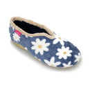 Top angled view of a cosy slipper featuring a navy blue fuzzy fabric with large white daisy prints, orange centres, beige faux-fur trim, and a tan sole. A small pink brand tag is visible on the heel.