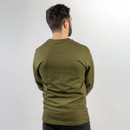A person with short dark hair, wearing an olive green long-sleeve shirt, stands with their back to the camera against a plain white background. A person with short dark hair, wearing an olive green long-sleeve shirt, stands with their back to the camera against a plain white background.