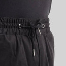 Close-up of adjustable drawcord waistband on black CAT work trousers with metal aglets.