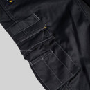 Close-up of utility pocket and strap on black CAT work trousers with reinforced seams and heavy-duty stitching