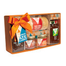 Gift box with pâté jars, chutneys, and Scottish oatcakes. It has a colorful geometric pattern and an orange bow, creating a festive, gourmet feel.