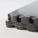Detailed image of black EVA foam mats stacked together, highlighting robust interlocking edges and shock-absorbing texture suitable for heavy-duty use.