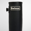 Detail shot of the Barbour logo patch on the upper shaft of a black rubber wellington boot.