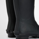 Close-up of the heel and ankle area of black Barbour wellington boots showing smooth rubber finish.