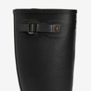 Close-up of adjustable buckle detail on black Barbour wellington boot shaft with embossed branding.